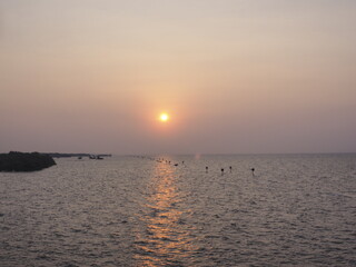 The morning sun rises where tourists are popular to come to visit the sea temple and see the local fishermen lifestyle next to the sea