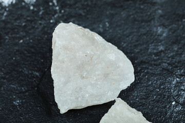 Crystalized salt rocks on dark background. Close up