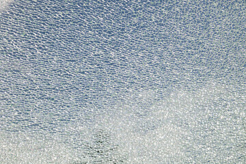 Cracked, broken safety glass, many small fragments, mesh