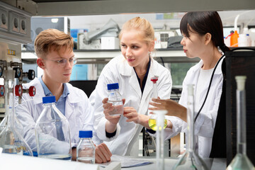 Portrait of efficient positive group of European and Chinese scientists working together at biochemical laboratory