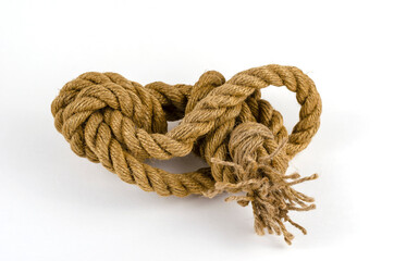 Hemp rope with tied knot in close-up on white background.