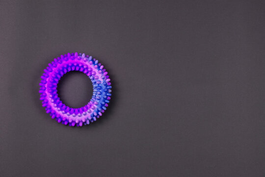 Erection ring with spikes on a gray background.