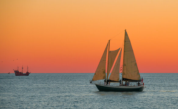 Sailboat Or Sail Yacht. Private Cruise Or Sunset Tour. Summer Vacations On Ocean Or Gulf Of Mexico Florida. Yachting Sport. Beautiful Seascape. Red Sky After Sunset.