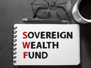 SWF Sovereign wealth fund, text words typography written on book against dark background, life and...