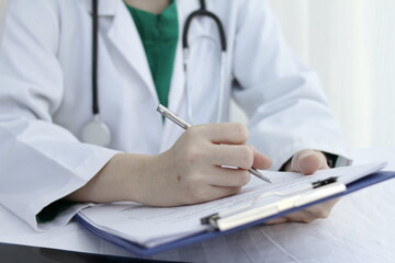woman doctor sitting at work Hand with pen and document file, concept Doctor work