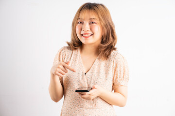 Obraz premium Young asian girl holding phone with expressions, gestures on background