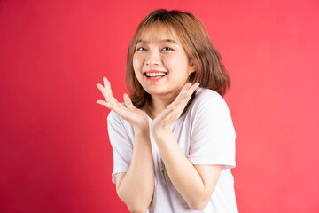 Young asian girl with cheerful gestures and expressions on background