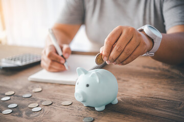 Obraz na płótnie Canvas Hand holding coin with pig piggy bank. Saving and financial accounts concept.