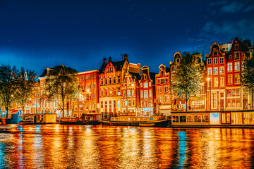Obraz premium Famous Amstel river and night view of beautiful Amsterdam city. Netherlands
