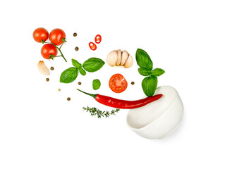 Tomato, basil, spices, chili pepper, garlic fresh thyme flying. Vegan diet food isolated on white. Falling into bowl, levitation fly. Creative concept