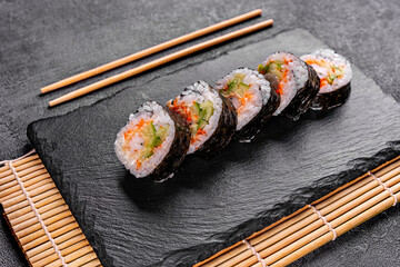 Sushi Rolls with fresh fish and cheese inside. Roll on glass black background. Sushi menu. Japanese food.