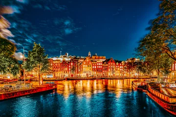 Schilderijen op glas Beautiful Amsterdam city at the evening time. © BRIAN_KINNEY