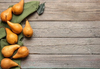 Fresh ripe pears on wooden background