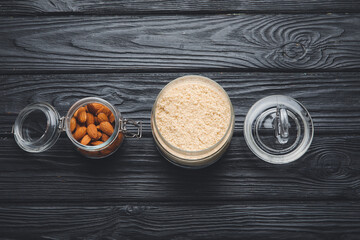 Bowl with almond flour on wooden background