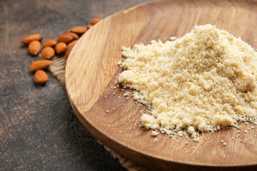 Plate with almond flour on dark background