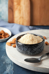 Bowl with almond flour on color table