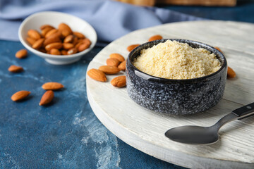 Bowl with almond flour on color table