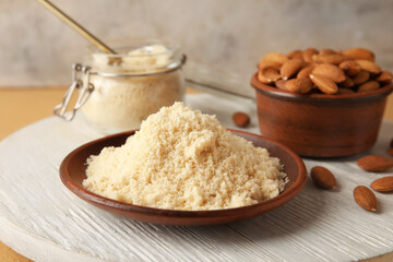 Plate with almond flour on table