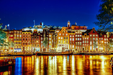 Famous Amstel river and night view of beautiful Amsterdam city. Netherlands - obrazy, fototapety, plakaty