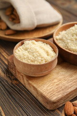 Fototapeta na wymiar Bowls with almond flour on wooden background
