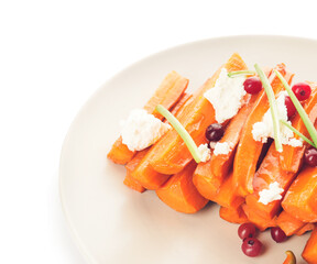 Plate of tasty baked carrot on white background