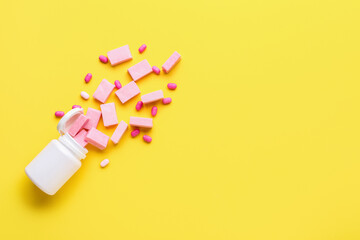 Container with chewing gums on color background
