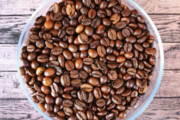 Brown coffee beans lie on a plate