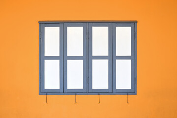 Simple white window on orange concrete wall.