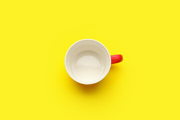 Empty cup on color background