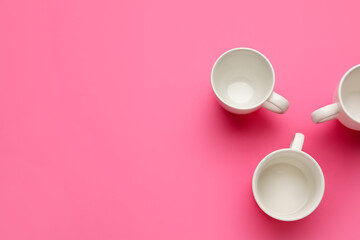 Empty cups on color background