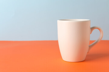 Empty cup on color background