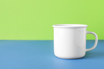 Empty cup on color background