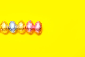 Sweet chocolate eggs on color background