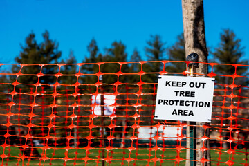 Keep out, Tree protection area sign on orange tree protection plastic mesh fencing
