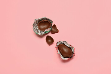 Sweet chocolate eggs on color background