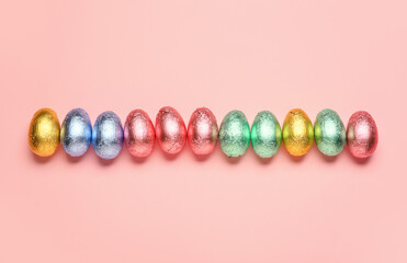 Sweet chocolate eggs on color background