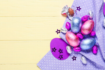 Beautiful composition with chocolate Easter eggs on wooden background