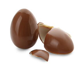 Whole and broken chocolate Easter eggs on white background