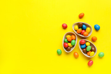 Composition with chocolate Easter eggs on color background