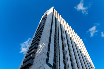 Blue-gray modern multi-storey building against blue sky