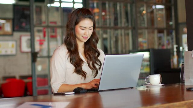 Happiness Attractive Asian woman working with computer laptop thinking to get ideas and requirement in Business startup at modern office or Co-working space,Business Startup Concept