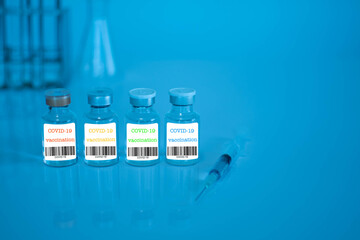 Four coronavirus vaccine bottles are placed on the table in the lab. Four types of COVID-19 vaccine. Scientific laboratory concept invented a cure for coronavirus disease (COVID-19). Selective focus.