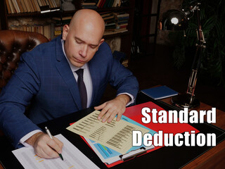 Business concept meaning Standard Deduction Businessman, executive manager hand filling paper...
