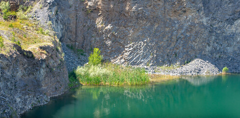 the emerald green lake between the rocks of the mountain