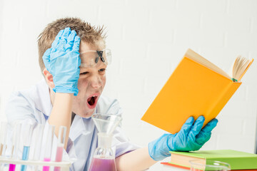 Funny boy dressed as chemist with dirty face after a failed experiment
