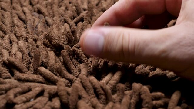 Brown soft carpet. True macro close up revealing it's texture. Gentle and fluffy micro fiber between fingers. Hand touch