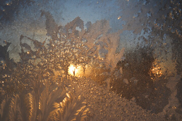 Window with frost at dawn in winter