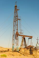 Fototapeta na wymiar Pumping unit as the oil pump installed on a well. Equipment of oil fields Azerbaijan
