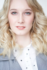 Naklejka premium Portrait of beautiful blonde business woman on white background smiling