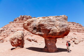 Man standing under big balancing rock, Utah, USA